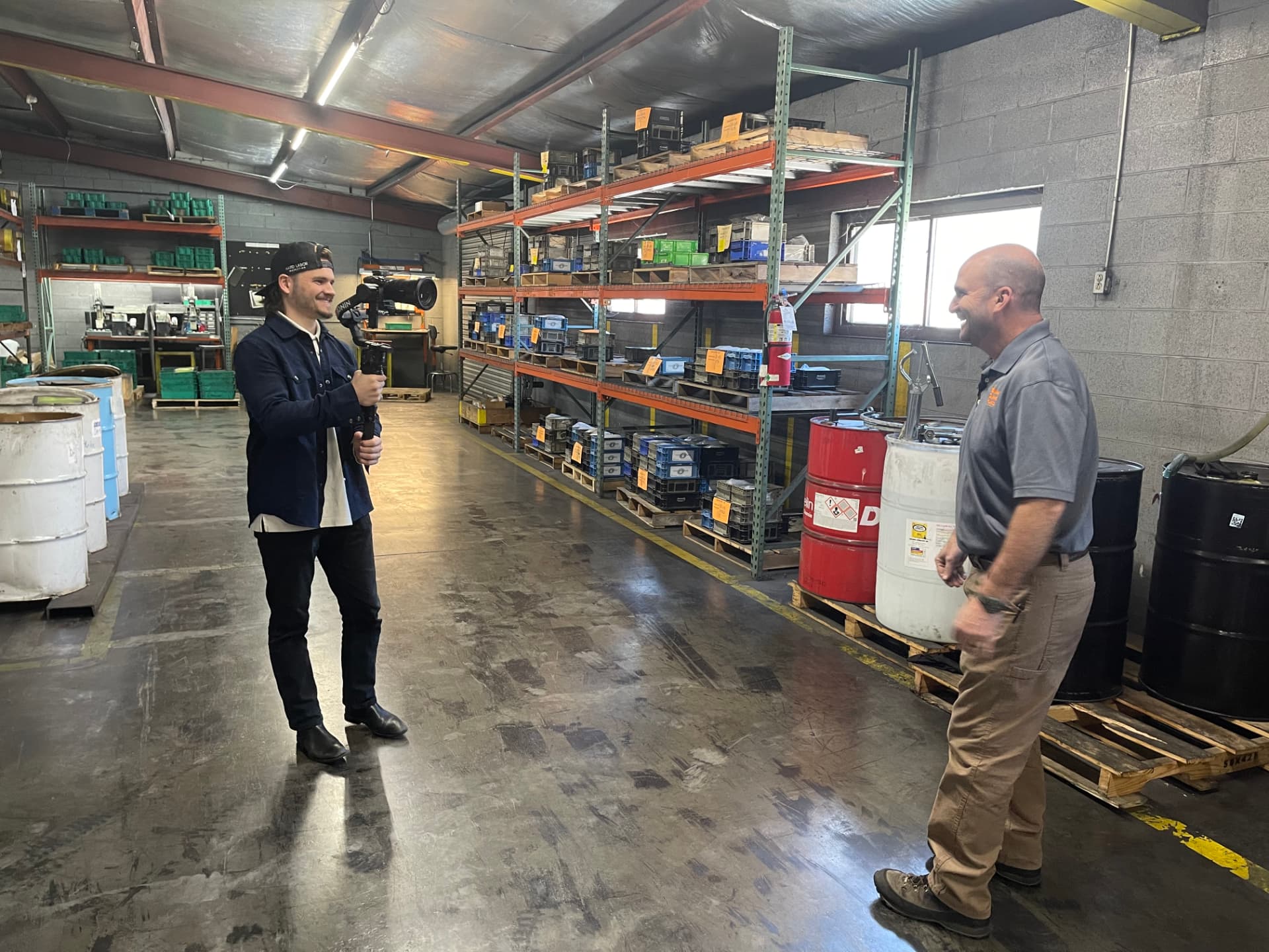 Videographer filming an interview with a VSP leader in the warehouse aisle