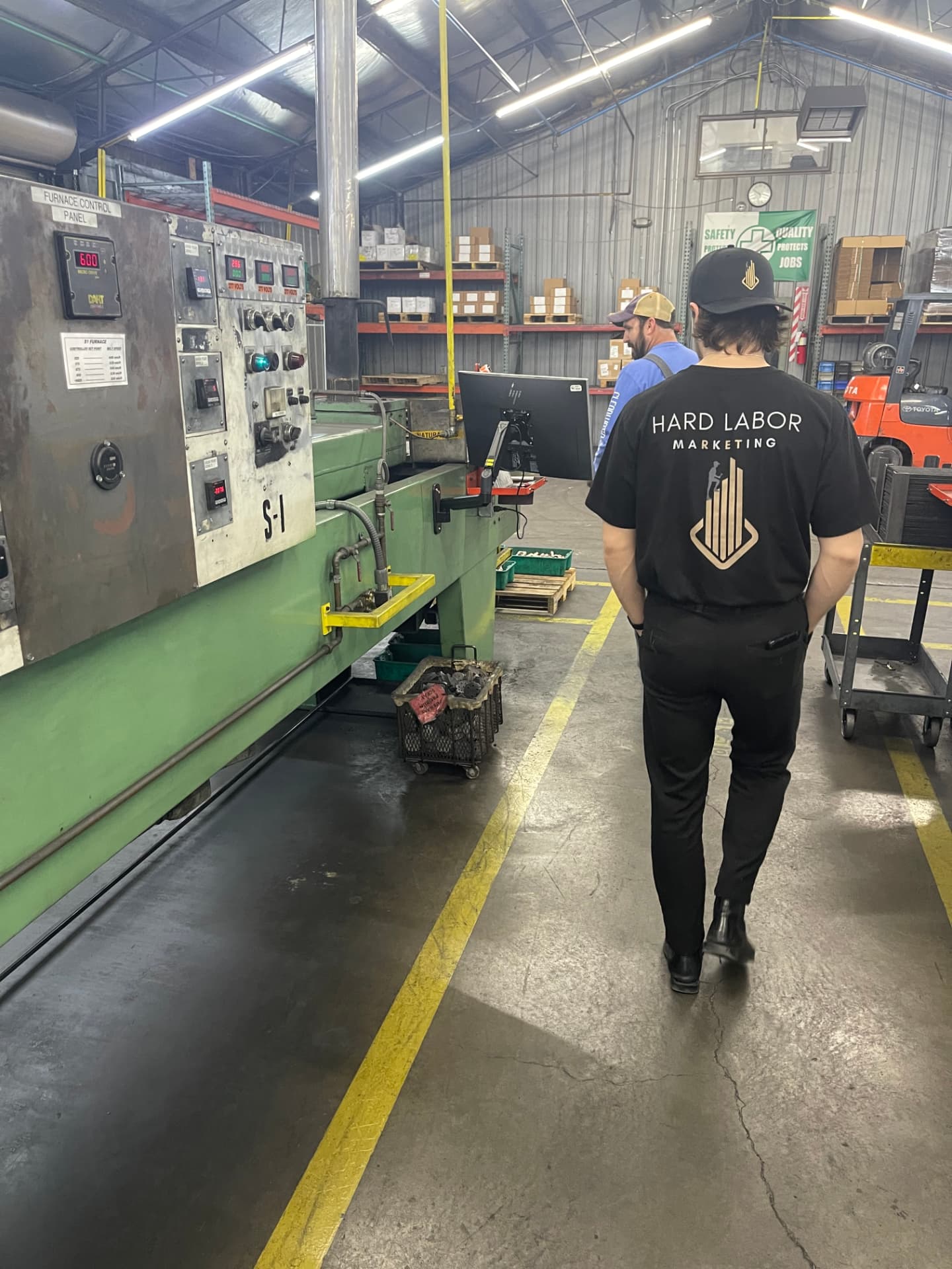 Hard Labor Marketing team member walking the sintering furnace line inside the VSP plant