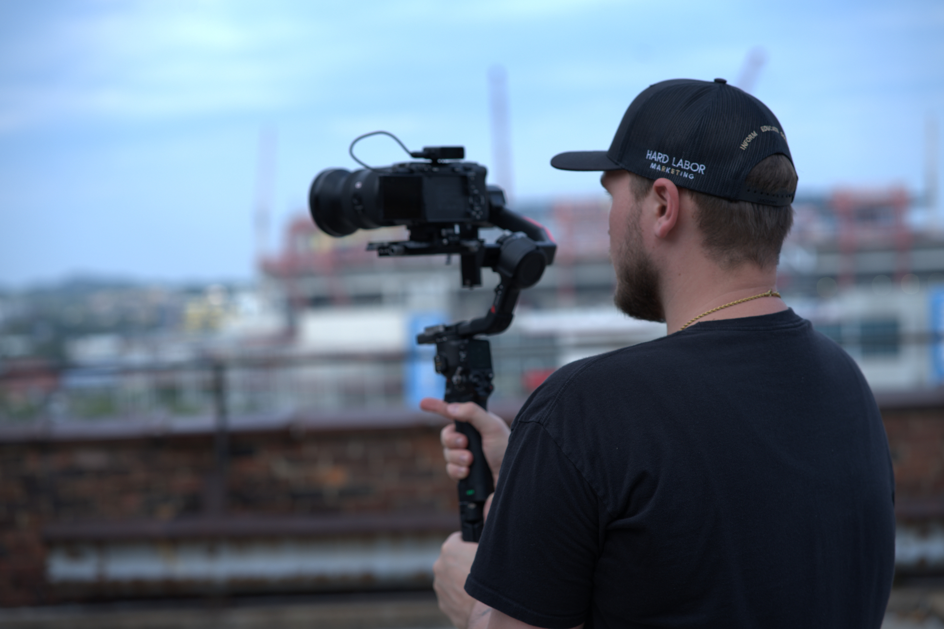 HLM operator framing a shot with a cinema camera on a rooftop