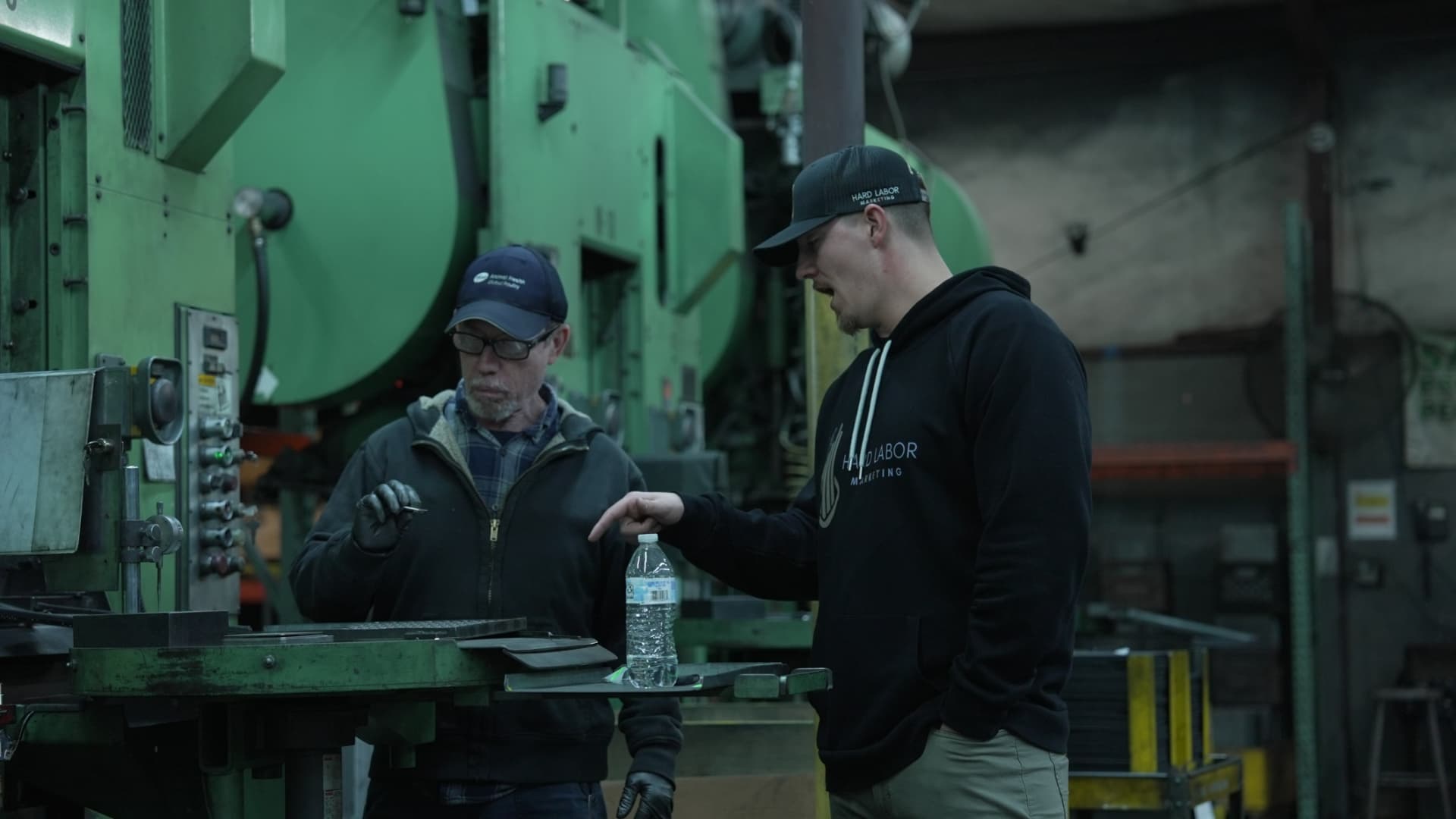 Hard Labor Marketing team member reviewing sintered metal parts with a VSP machine operator