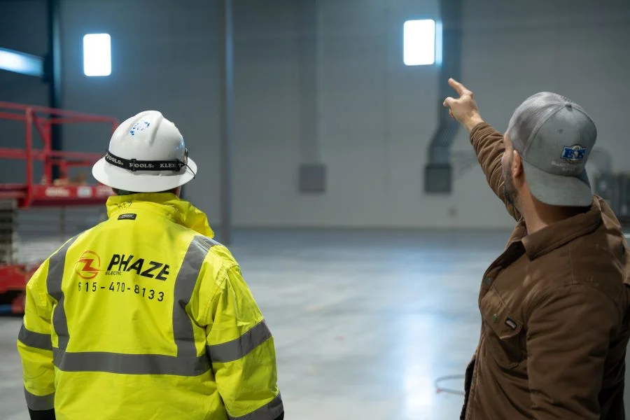 Phaze Electric foreman walking a warehouse site with the general contractor