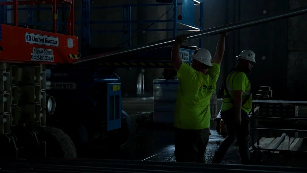 Phaze Electric crew running conduit inside a large facility